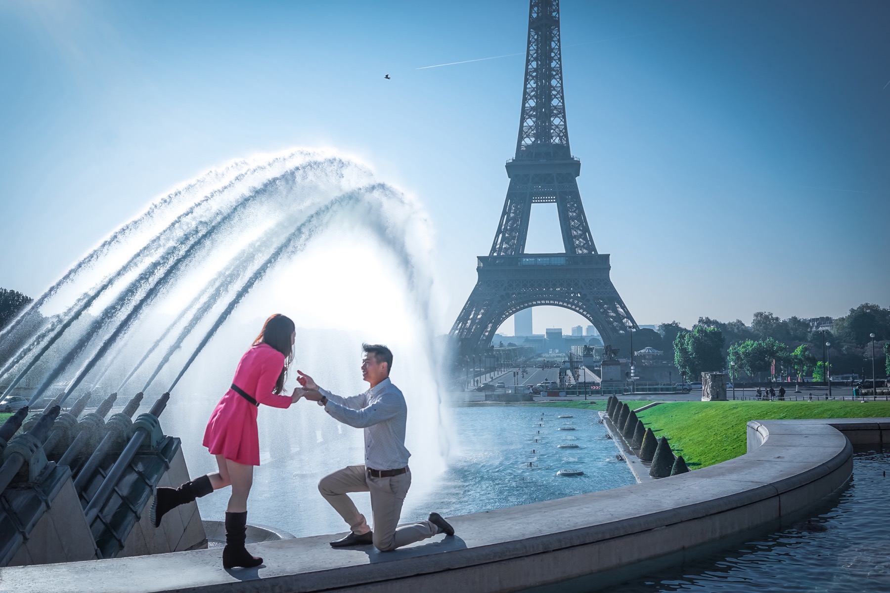 Man proposing on one knee in front of the Eiffel Tower in Paris