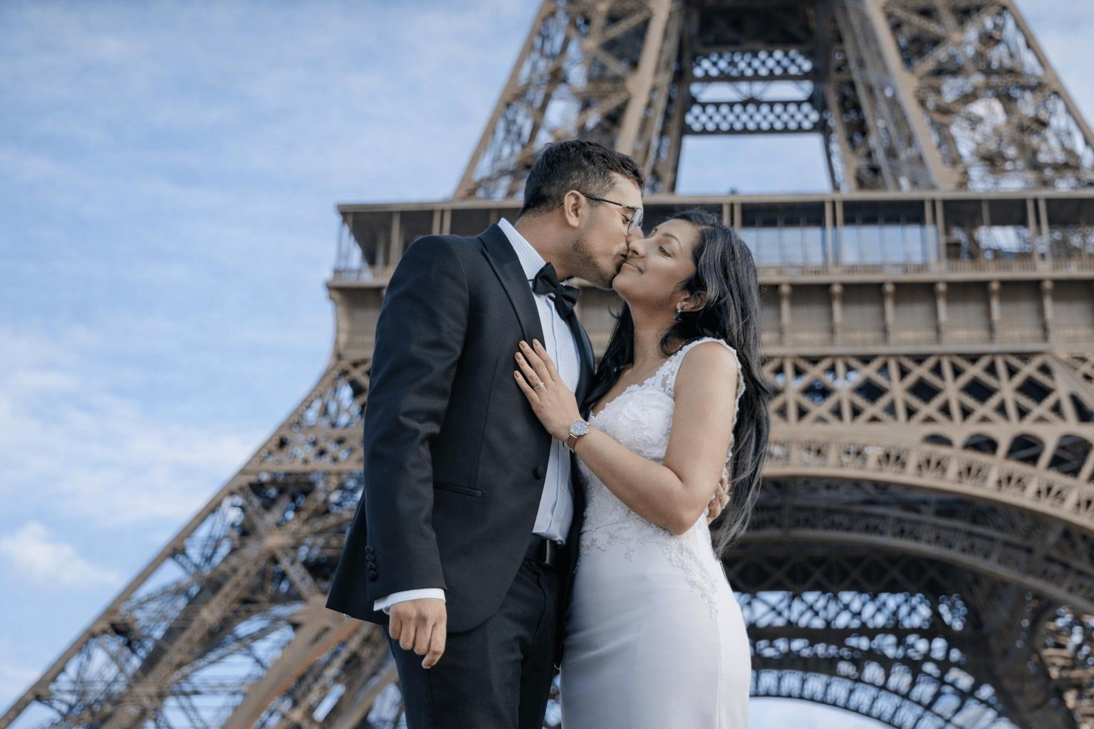 Romantic kiss in front of the Eiffel Tower during Paris proposal